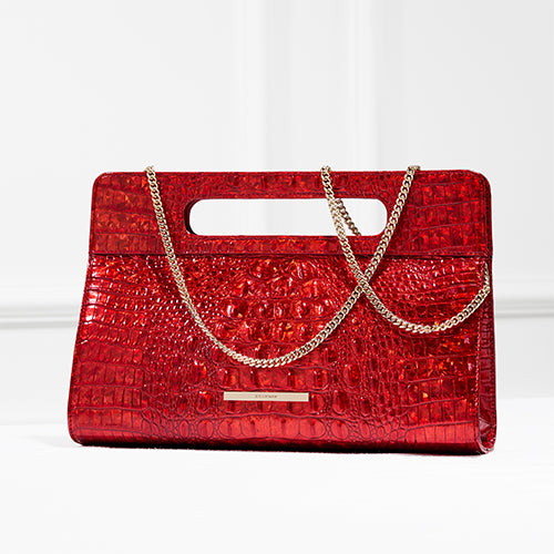 Brahmin clutch in vibrant red croc-embossed leather, featuring a slim rectangular silhouette, cut-out top handle, and detachable gold chain strap for versatile carrying.