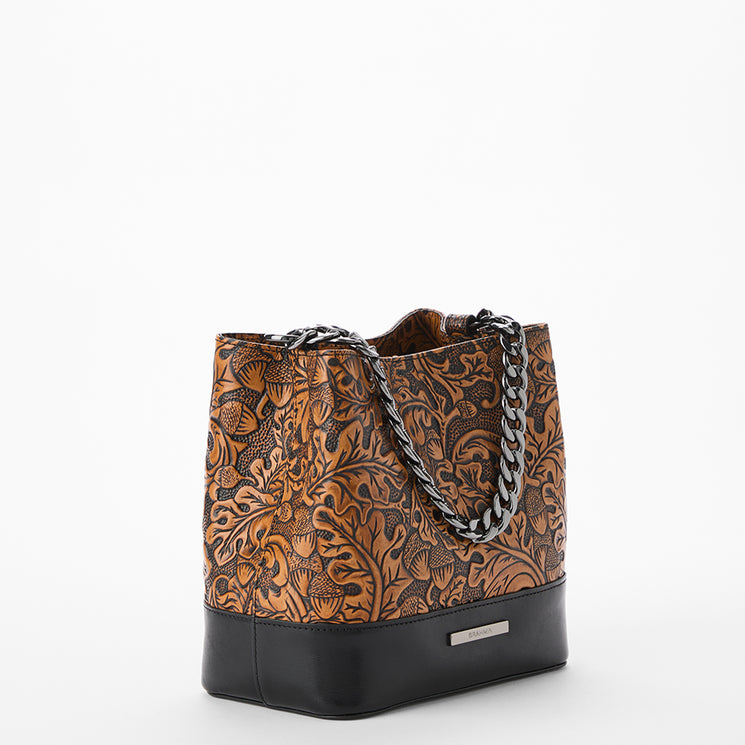 Brown patterned handbag with black accents on a white background. Mod Mini Amelia side view.