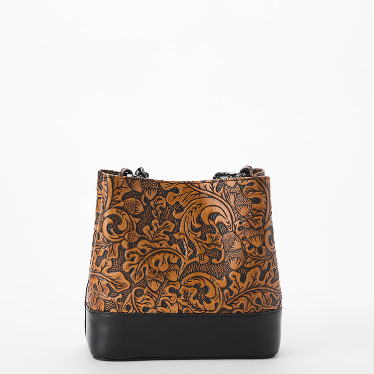 Brown patterned handbag with black accents on a white background. Mod Mini Amelia back view.