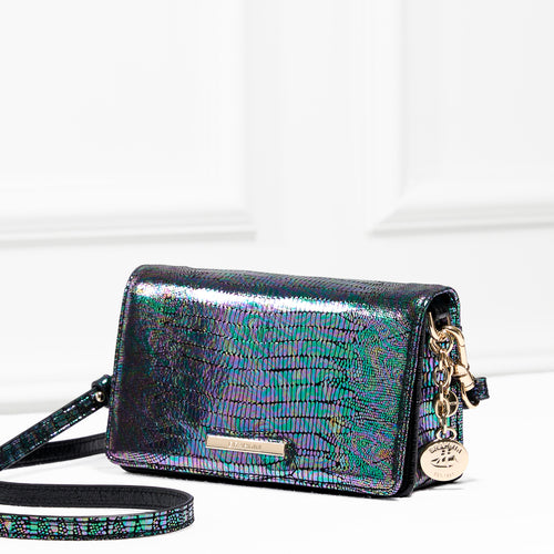 Brahmin Minuette crossbody bag in iridescent croc-embossed leather with shimmering green and black tones, featuring a flap closure, detachable long strap, and Brahmin medallion charm for versatile wear.
