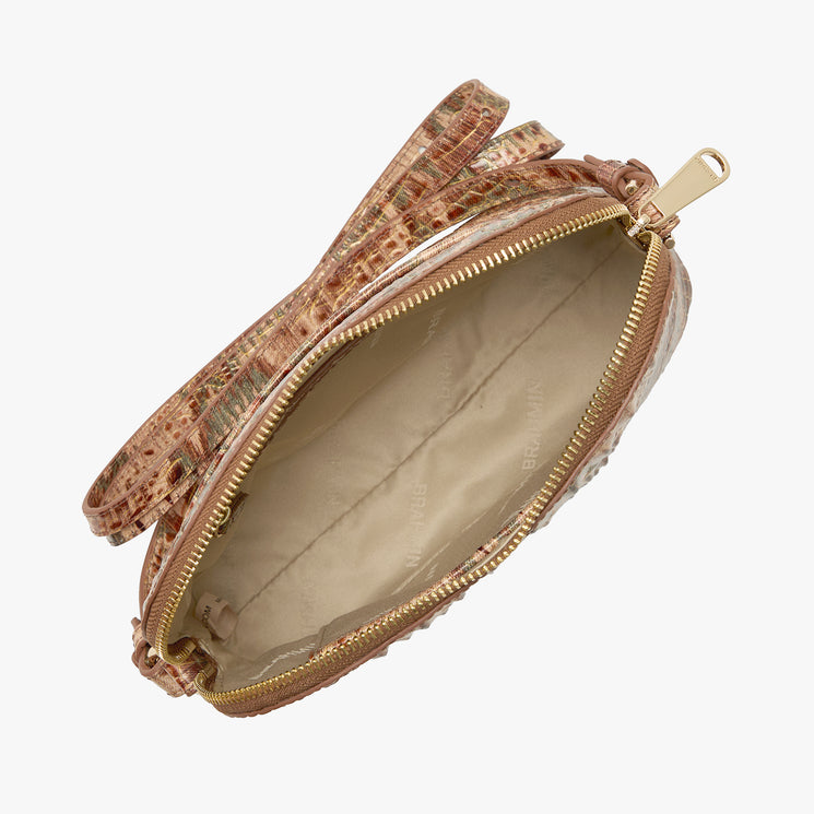 A small dome-shaped crossbody bag with a textured crocodile skin pattern in shades of brown, beige, and muted green, featuring a gold Brahmin plaque on the front. Amal Open Top View.