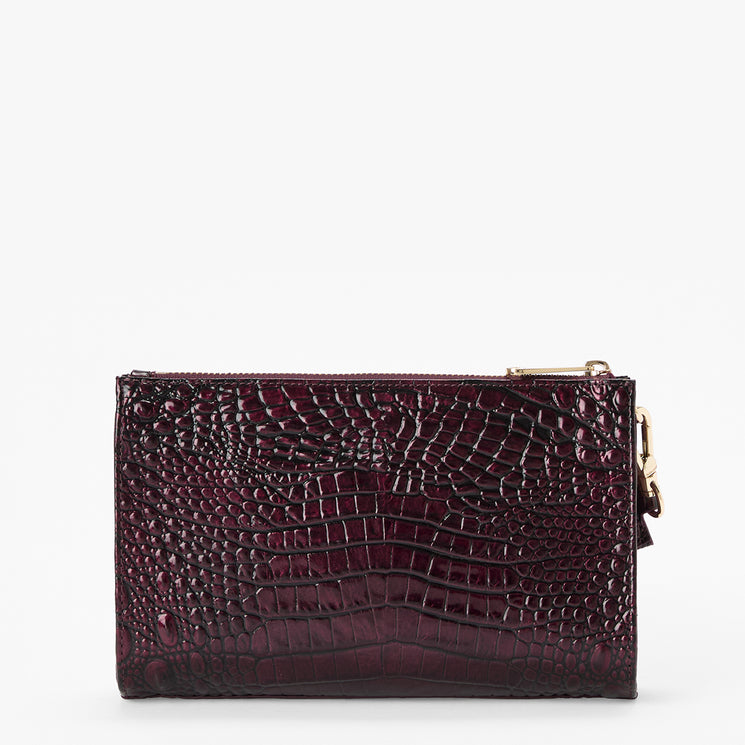 A rectangular clutch bag with a glossy crocodile-embossed texture in deep burgundy, featuring gold-tone zipper hardware, set against a plain white background.