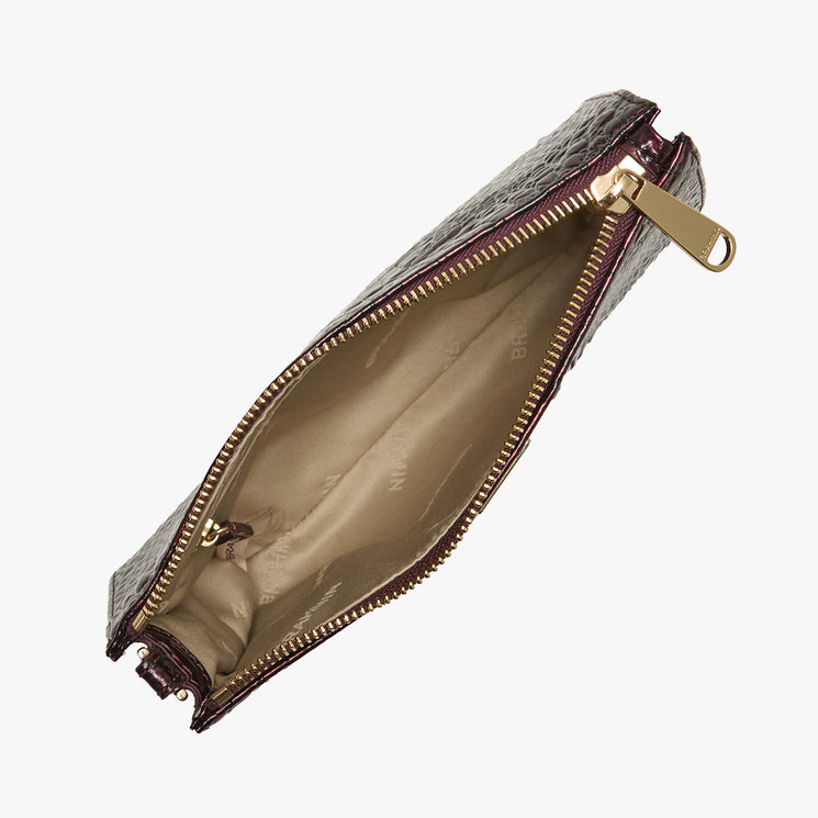 A dark burgundy textured leather pouch with a gold zipper and a beige interior lining, shown open against a plain white background.