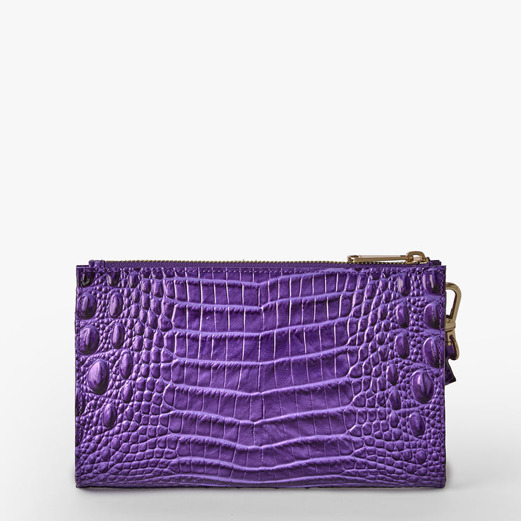 Brahmin purple zippered wallet with embossed textured pattern, shiny finish, gold-tone side clasp, rectangular shape; shown on a plain white background. No strap or interior features visible.
