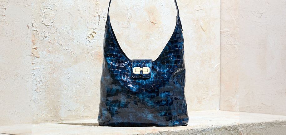 Brahmin blue shoulder bag on textured stone background