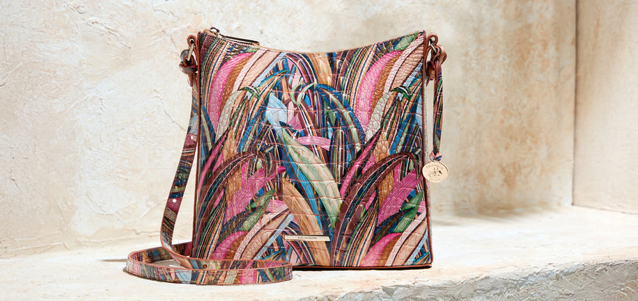 Brahmin colorful patterned crossbody bag on a light stone surface