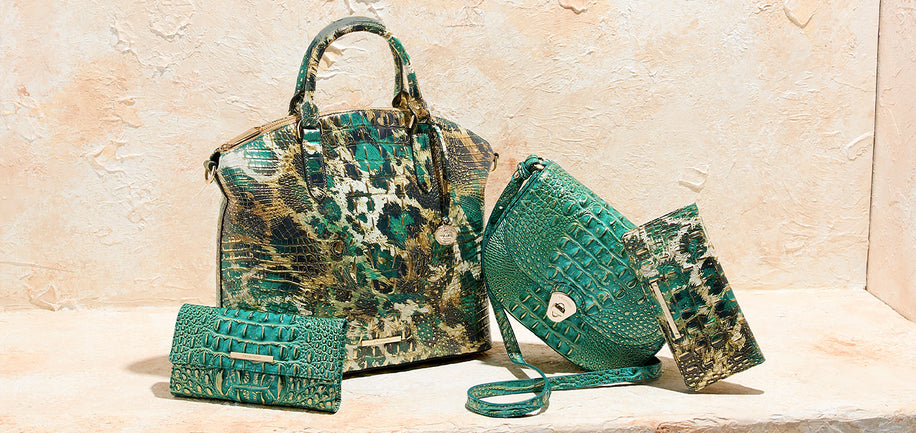 Set of green patterned handbags on a beige surface