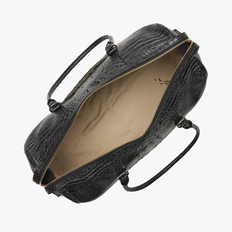 Brahmin black textured leather handbag with two top handles, shown from above unzipped to display a beige lined interior, small key clip, and spacious compartment. Structured silhouette; elegant, practical design.