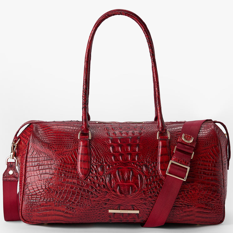 Brahmin red embossed leather handbag with gold hardware, two top handles, adjustable shoulder strap, structured silhouette, and textured pattern shown on a white background.