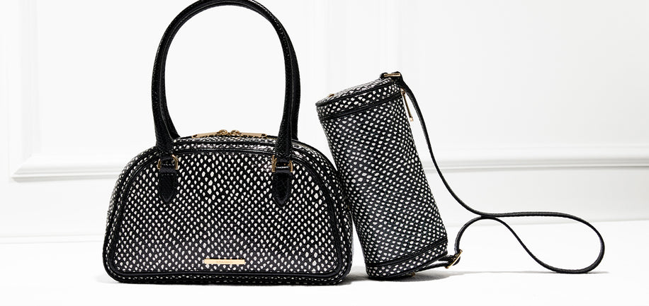 Two black and white handbags with textured patterns on a white background