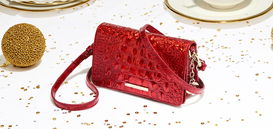 Minuette Red Opal Melbourne handbag on a white surface with gold accents