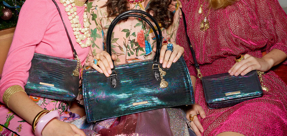 Three sisters holding Minuette, Sophia, and Lorelei handbags