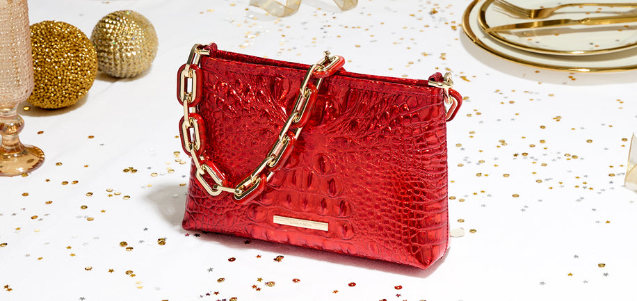 Red Opal Melbourne Mod Lorelei with gold chain on a white background with gold confetti