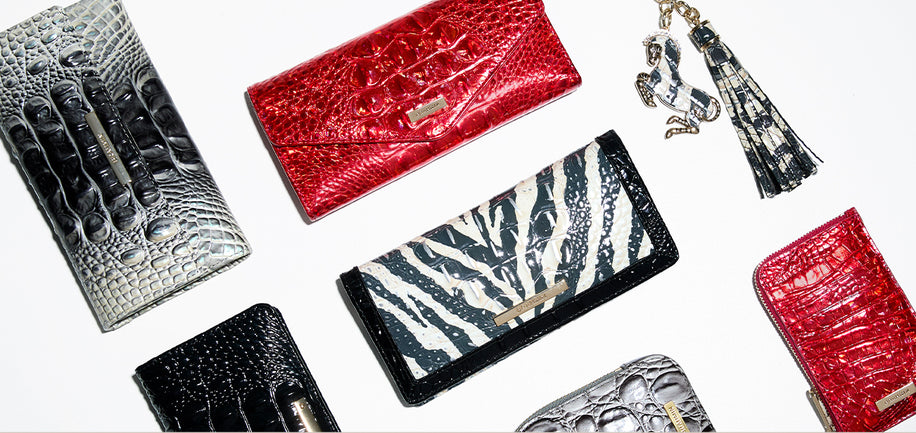 Collection of various wallets with different designs and colors on a white background