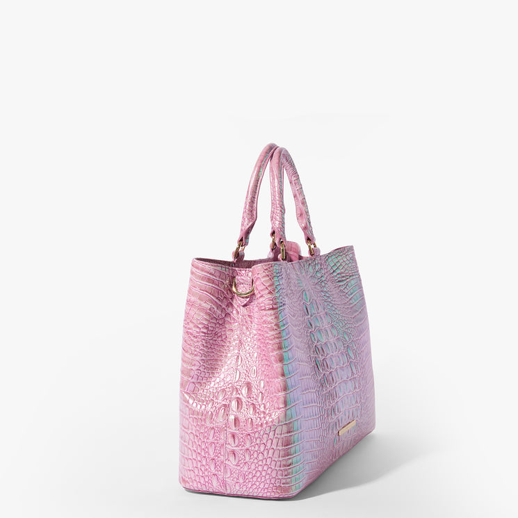 Brahmin pink and purple iridescent embossed handbag with gold hardware, two top handles, structured silhouette, and textured pattern, displayed upright against a plain white background.