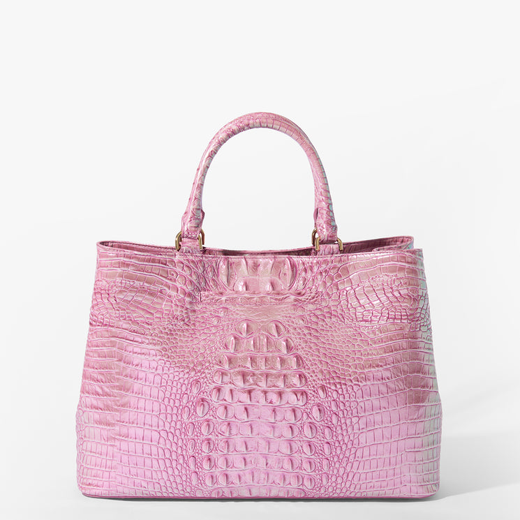 Brahmin pink satchel handbag with embossed texture, dual top handles, structured silhouette, gold-tone hardware, and a glossy finish, set against a white background. No strap or interior details visible.