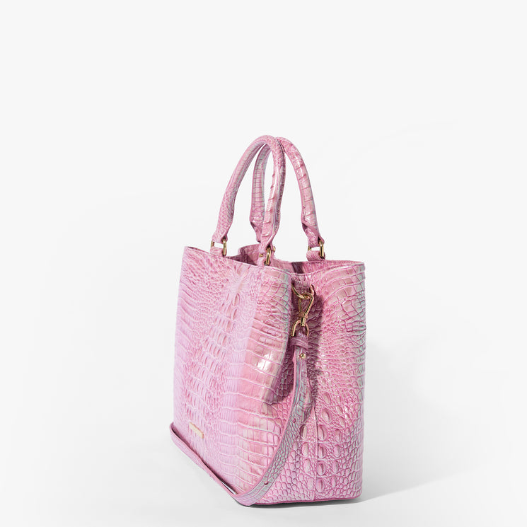 Brahmin pink embossed handbag with gold hardware, two short handles, and a detachable shoulder strap, showcasing a structured silhouette and crocodile-inspired texture on a white background.