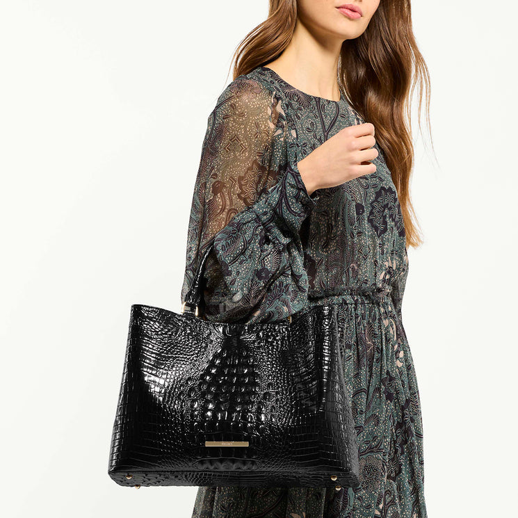 Woman holding black melbourne Denise handbag against a white background