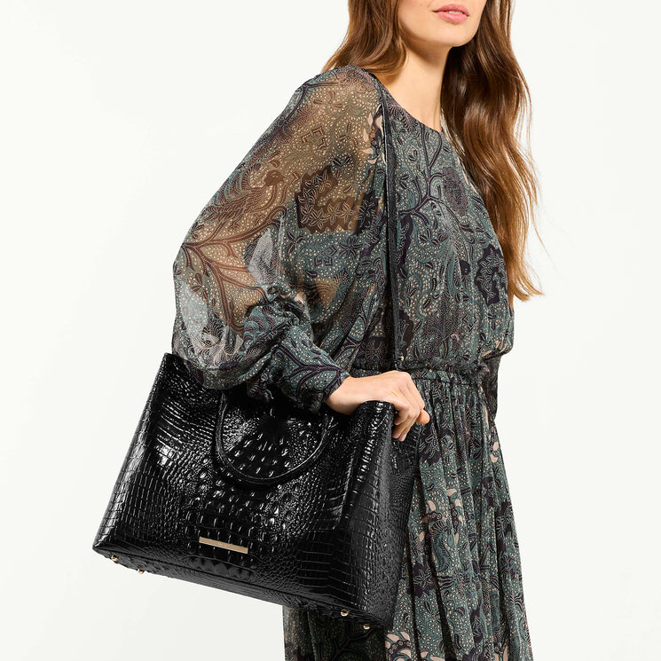 Model wearing black melbourne denise crossbody handbag against a white background