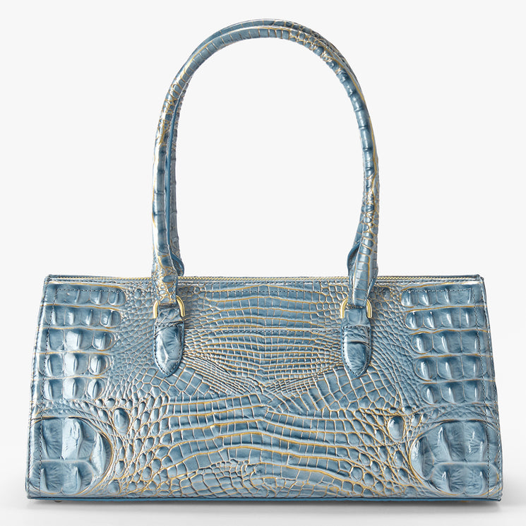 A structured blue crocodile-embossed handbag with dual top handles and gold-tone hardware, photographed against a clean white background.
