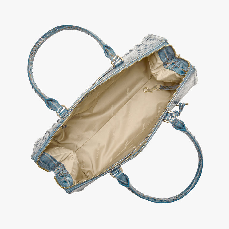 An open light blue textured handbag with a beige satin interior, shown from a top-down view on a white background.