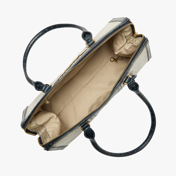 Brahmin tote top view showing open beige silhouette with dark handles, spacious light tan interior, side pockets, key clip, and signature lining. Bag rests on white background; ideal for shoulder carry.