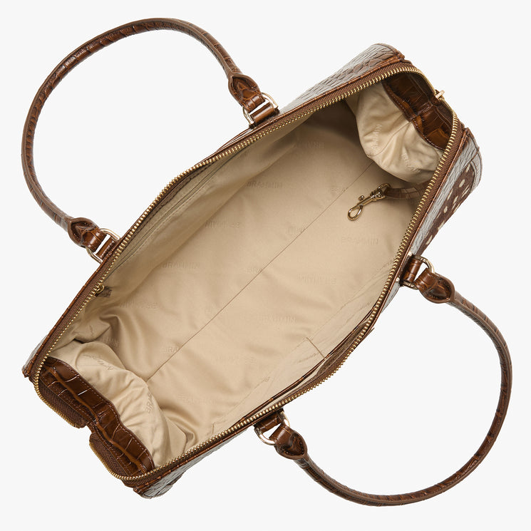 Brahmin brown textured handbag with embossed pattern, top view showing zipper open to a spacious beige fabric-lined interior and small gold-tone clasp for keys, structured silhouette, no visible straps.