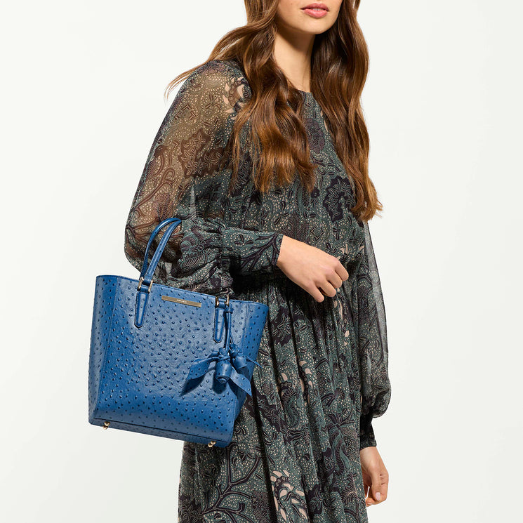 Model holding Harrison Satchel against a white background