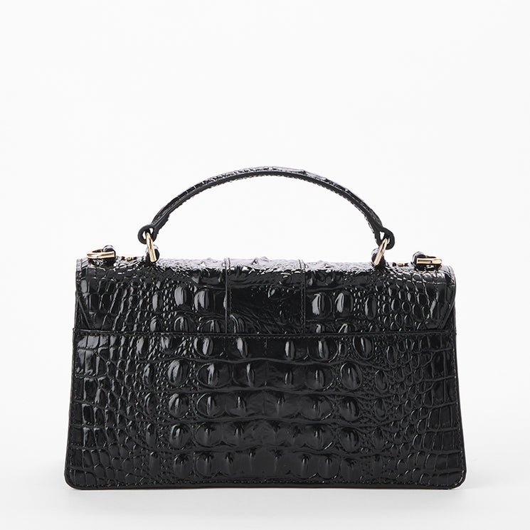 A black crocodile-embossed leather handbag with a top handle and gold-tone hardware, shown against a plain white background. Back view.
