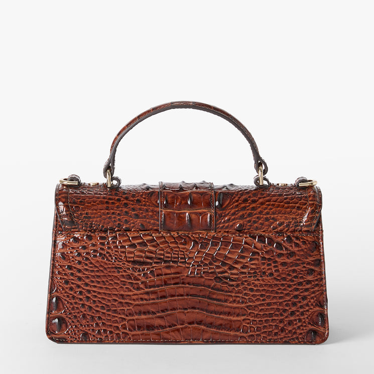 A structured brown crocodile-embossed leather handbag with a top handle, shown against a plain light gray background. Back view.