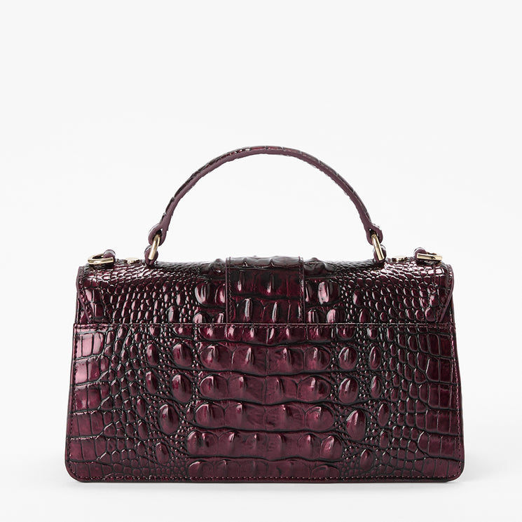 A dark burgundy crocodile-embossed leather handbag with a top handle, shown against a plain white background.