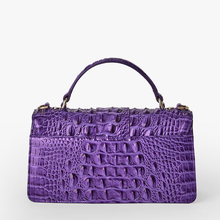 Brahmin purple embossed leather handbag with a structured rectangular silhouette, gold-tone hardware, single top handle, and signature textured pattern, shown upright against a white background.