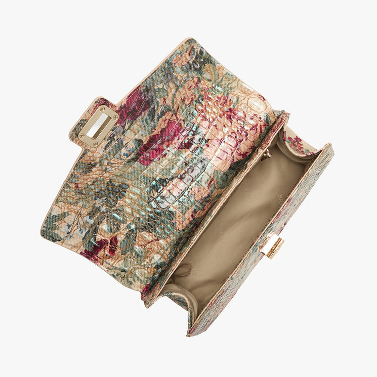 A textured clutch handbag with a vintage floral tapestry pattern in muted pink, green, and beige tones, shown open against a plain white background.