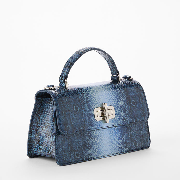 Blue snakeskin pattern handbag with a silver clasp on a white background. Side view.