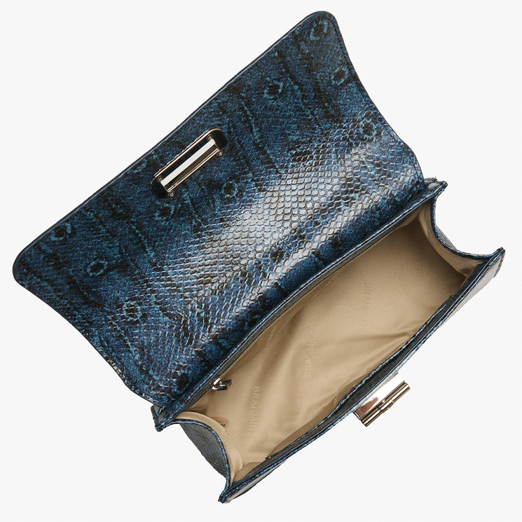 Blue snakeskin patterned clutch bag on a white background. Open top view.