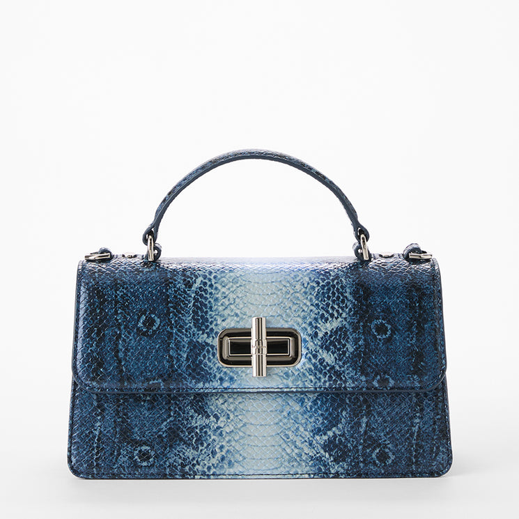 Blue textured handbag with a silver clasp on a white background. Front view with no strap.