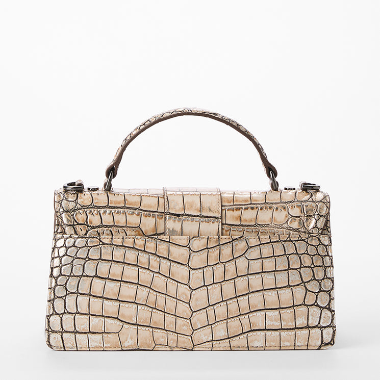 Beige crocodile-patterned handbag on a white background. Back view.