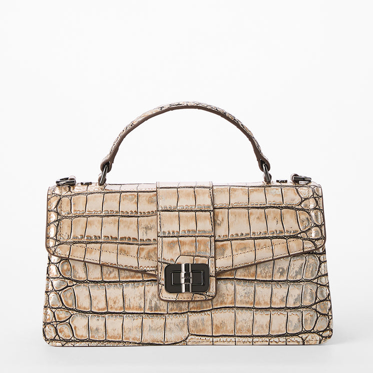 Beige crocodile-patterned handbag on a white background. Front view without strap.