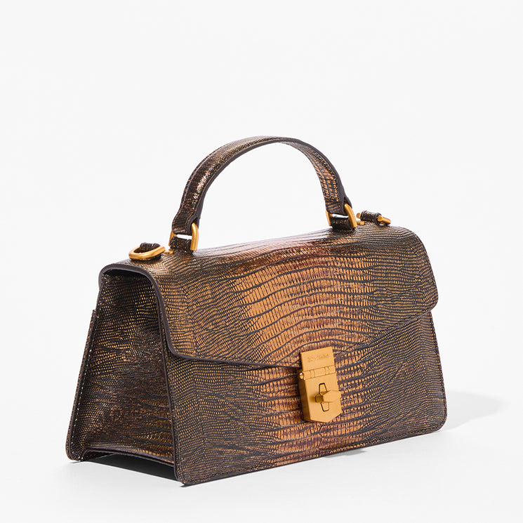 A structured top-handle handbag with a metallic bronze and brown textured leather exterior, featuring gold-tone hardware and a gold clasp on a white background.