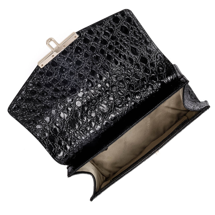 BRAHMIN Genie black purse with embossed textured pattern, structured silhouette, gold-tone clasp closure, top handle, visible beige lining, shown open on a white background.
