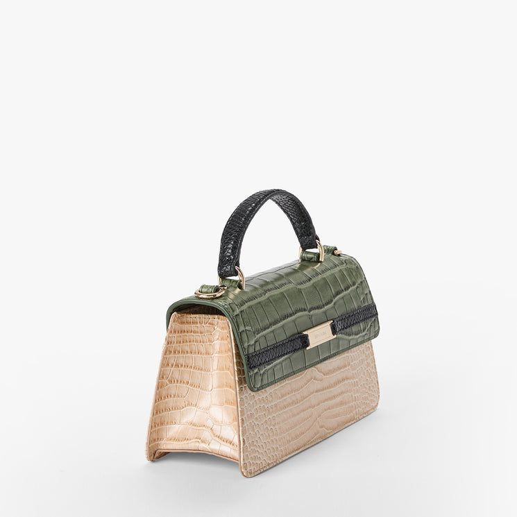 A structured handbag with a dual-tone crocodile-embossed leather design, featuring an olive green top flap and handle with a champagne beige lower body, accented by a black horizontal band and gold-tone hardware.