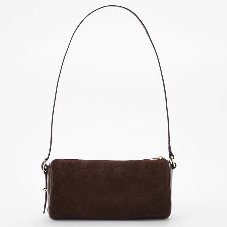A dark brown suede shoulder bag with a long, thin brown leather strap and small gold-tone hardware, shown against a plain white background.