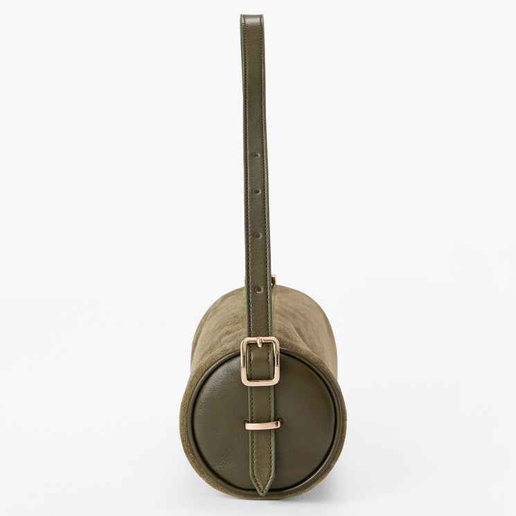 An olive green cylindrical shoulder bag with a matching leather strap and a gold-tone buckle closure, shown against a plain white background.