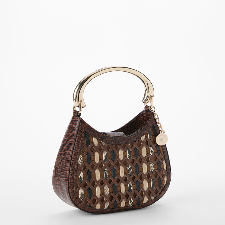 Patterned handbag with a gold handle on a white background. Brielle side view.