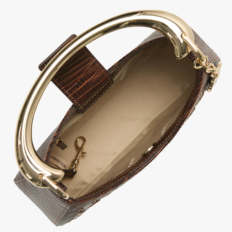 Patterned handbag with a gold handle on a white background. Brielle open top view.