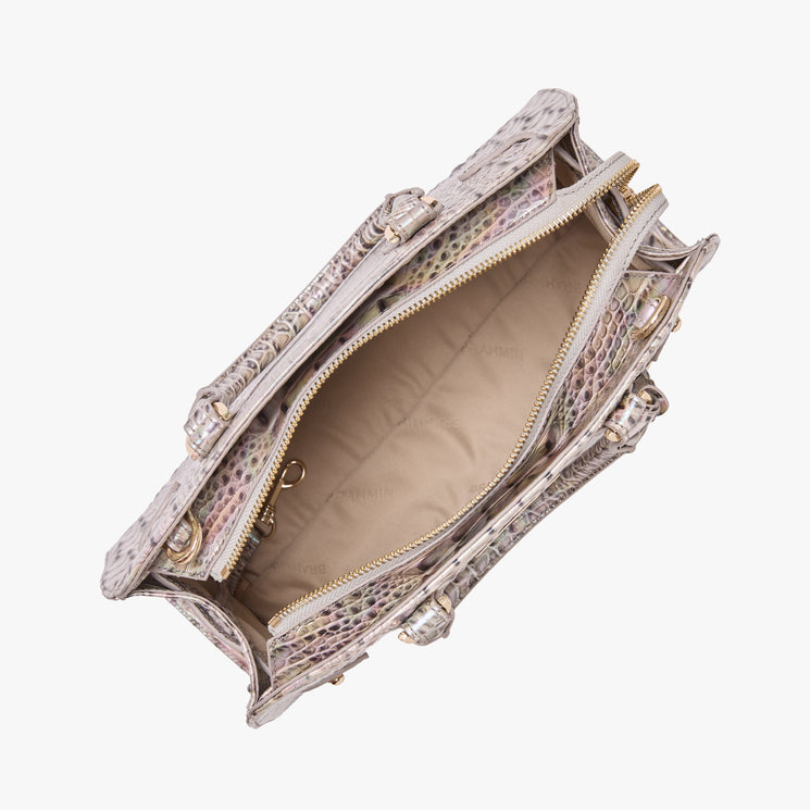 Brahmin handbag top view showing open silhouette with a textured pink and gray embossed pattern exterior, light beige interior, gold-tone zipper hardware, multiple compartments, and structured handles.