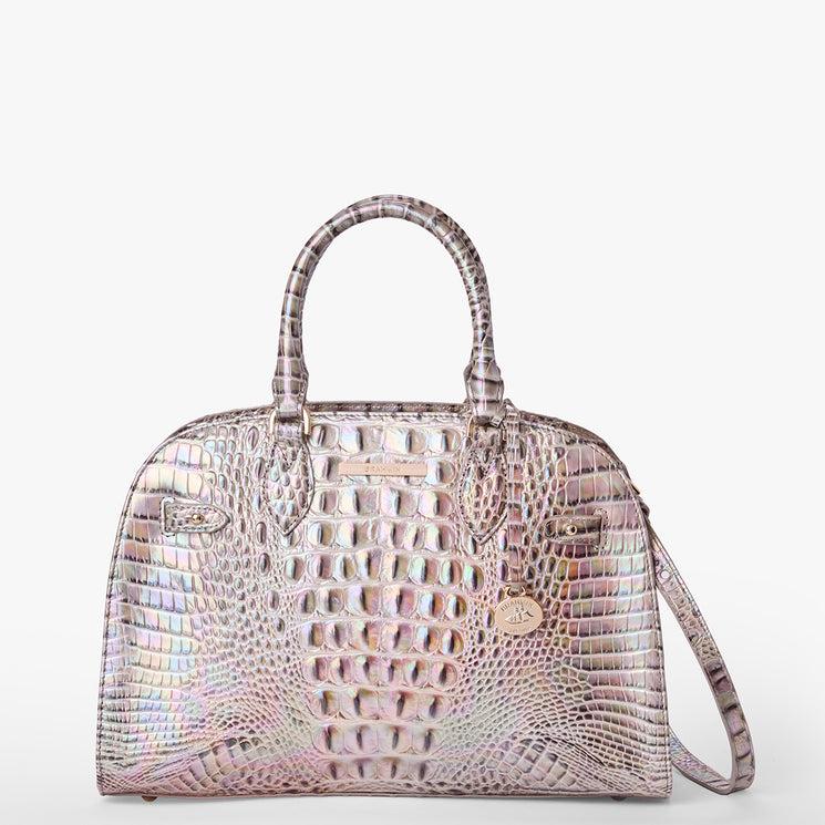 Brahmin metallic iridescent satchel with embossed texture, structured silhouette, dual top handles, removable shoulder strap, gold-tone hardware, and small charm detail; shown on a white background.
