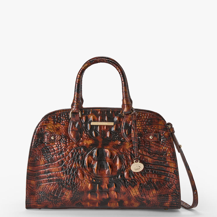 A brown crocodile-embossed leather handbag with dual top handles and a shoulder strap, shown against a plain light gray background.