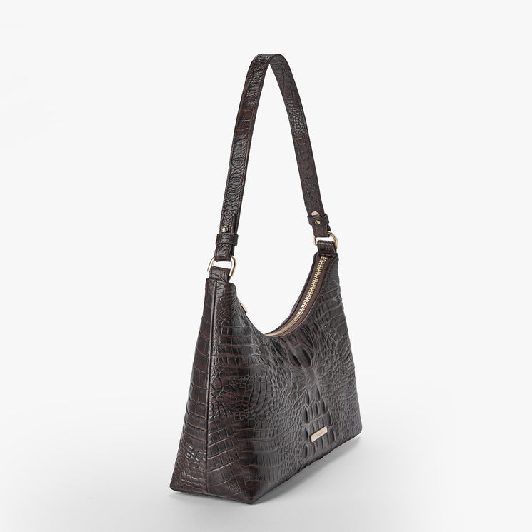 Brahmin dark brown embossed shoulder bag with single strap, zippered top, and textured pattern. The structured silhouette is shown angled on a white background, highlighting the elegant finish and classic hardware.