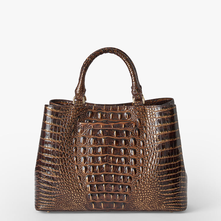 A brown crocodile-embossed leather handbag with dual top handles, photographed against a clean white background. Front view.